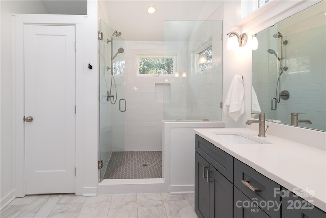 bathroom with marble finish floor, a stall shower, vanity, and recessed lighting