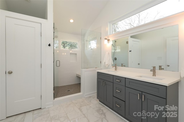 full bath with marble finish floor, recessed lighting, a sink, and a shower stall