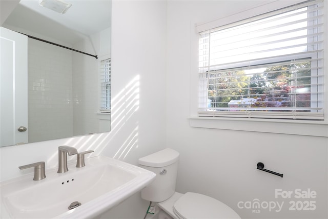 bathroom with visible vents, a sink, and toilet