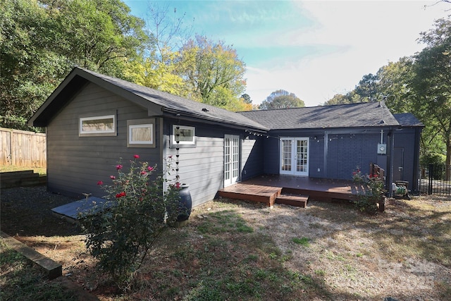 back of property with french doors, fence, and a wooden deck