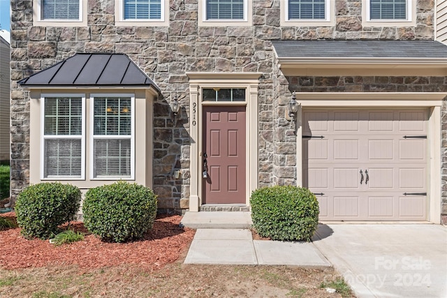 doorway to property featuring a garage