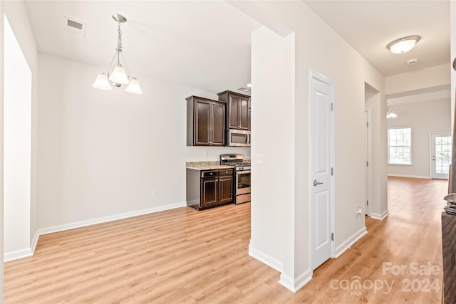 kitchen featuring stainless steel appliances, light hardwood / wood-style flooring, and dark brown cabinetry