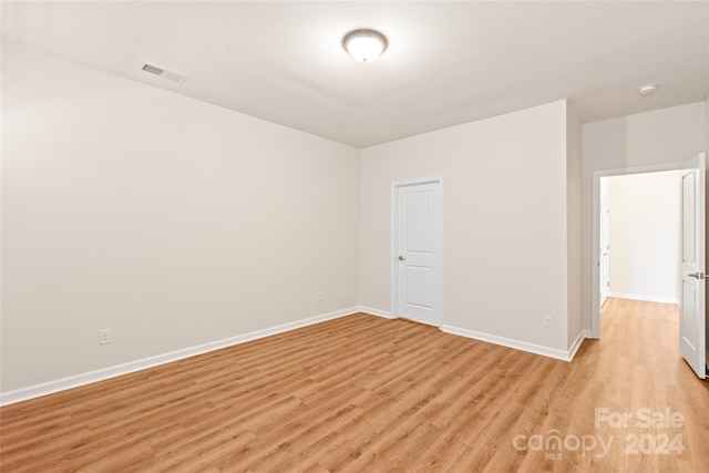 spare room featuring light hardwood / wood-style floors