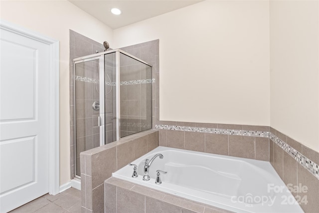 bathroom with tile patterned flooring and independent shower and bath