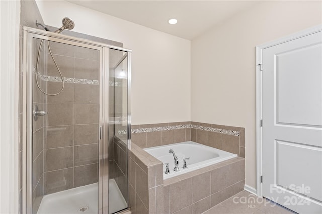 bathroom featuring shower with separate bathtub and tile patterned floors