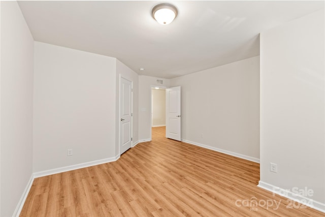 unfurnished room with light hardwood / wood-style flooring