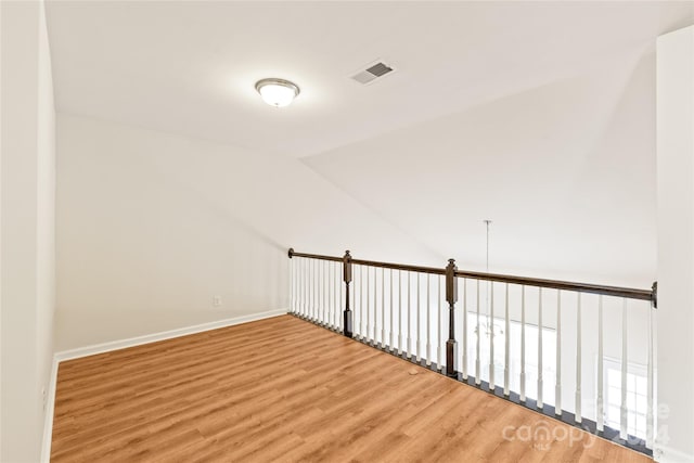 bonus room with lofted ceiling and hardwood / wood-style flooring