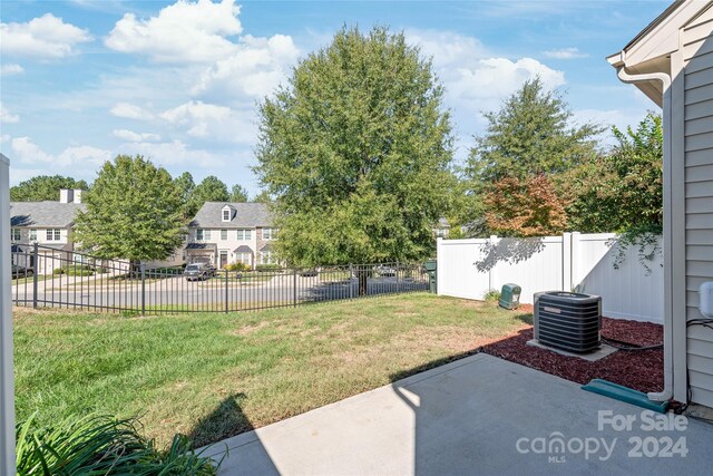 view of yard featuring a patio and central AC