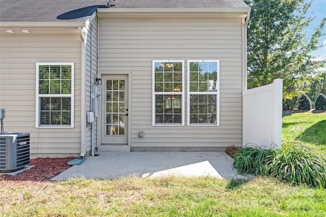 exterior space featuring a patio area, central AC, and a lawn