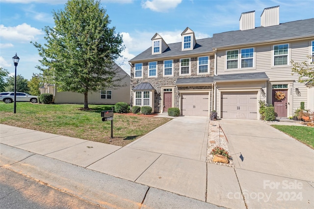 view of front facade with a garage and a front yard