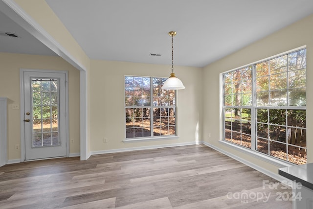 unfurnished dining area featuring light hardwood / wood-style floors