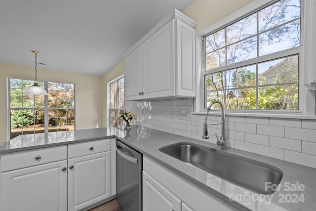 kitchen with white cabinets, dishwasher, a healthy amount of sunlight, and decorative backsplash