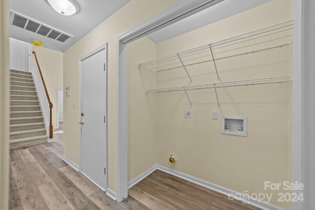 washroom with hookup for a washing machine, light hardwood / wood-style flooring, and hookup for an electric dryer