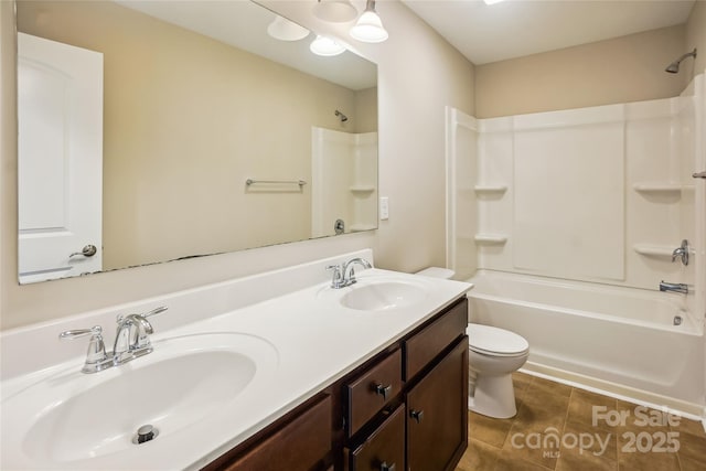 full bath with toilet, tile patterned floors, shower / tub combination, and a sink