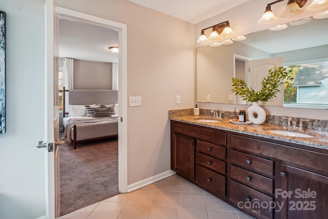 ensuite bathroom featuring double vanity, a sink, tile patterned flooring, and ensuite bath