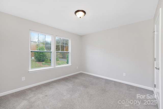 carpeted empty room with baseboards