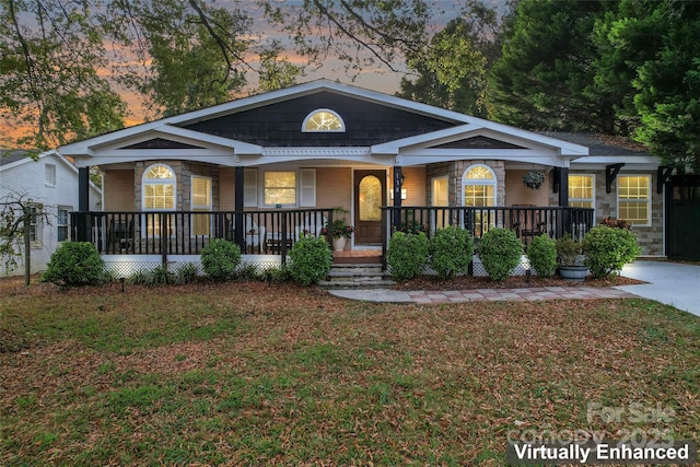 view of front of home with a yard and covered porch