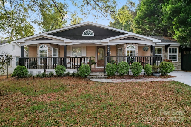 view of front of home with a front yard and a porch