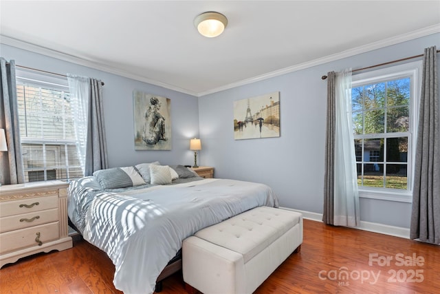 bedroom with dark hardwood / wood-style flooring and crown molding