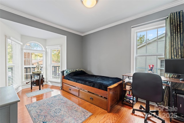 bedroom featuring light hardwood / wood-style floors and ornamental molding