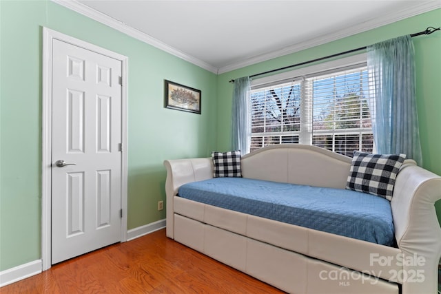 bedroom with wood-type flooring and ornamental molding