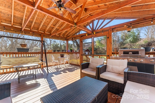 wooden deck featuring ceiling fan, a gazebo, and outdoor lounge area