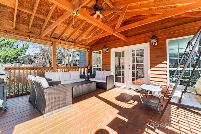 wooden deck with ceiling fan, french doors, and outdoor lounge area