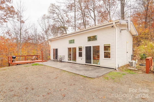 rear view of house featuring a patio and a wooden deck