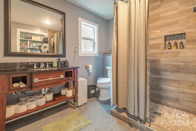 bathroom with a shower with shower curtain, wooden walls, toilet, and vanity