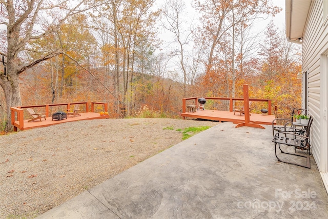 view of yard featuring a wooden deck and an outdoor fire pit