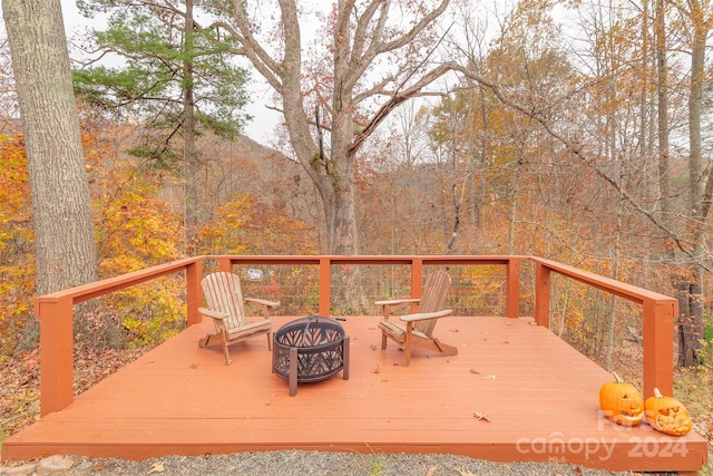 wooden terrace featuring a fire pit