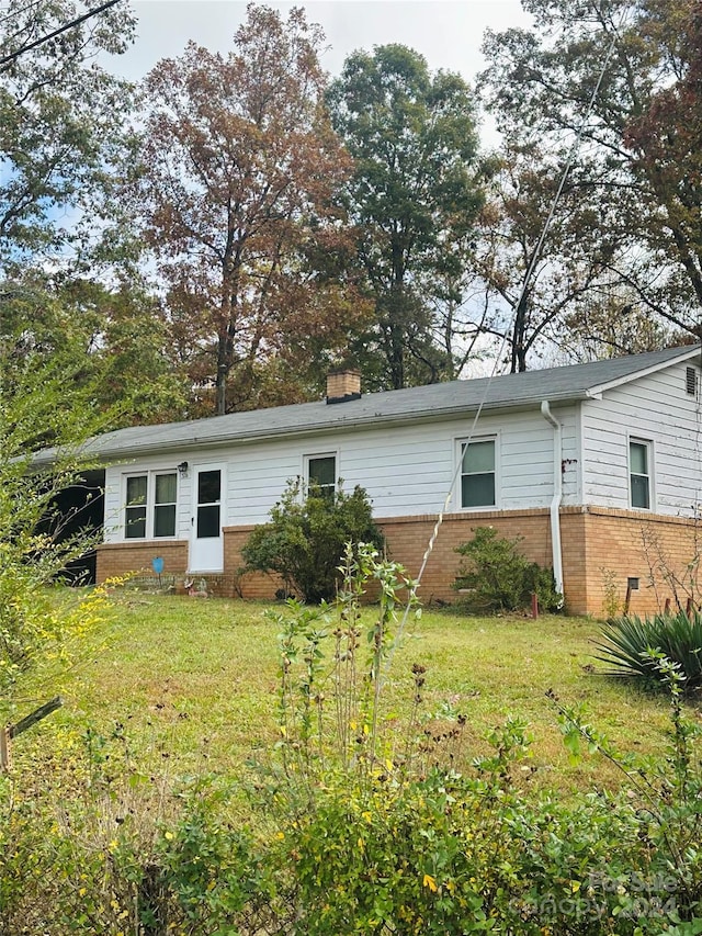 rear view of house with a lawn