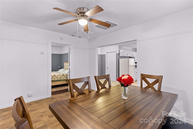 dining area with ceiling fan and light wood-type flooring