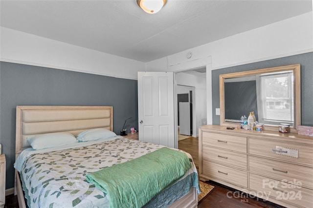 bedroom with dark wood-type flooring