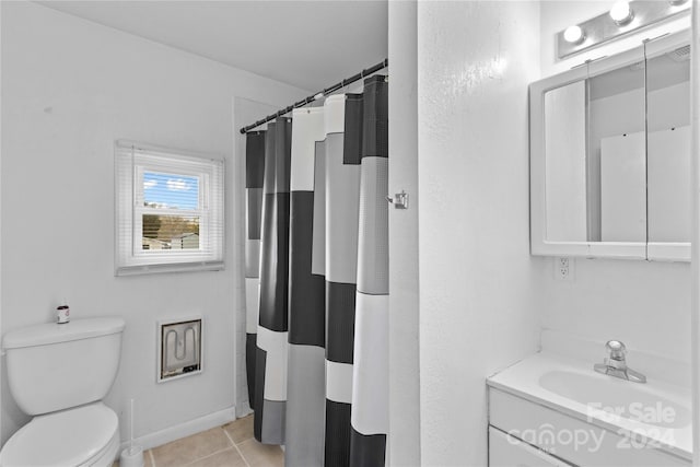 bathroom featuring toilet, vanity, a shower with shower curtain, and tile patterned floors