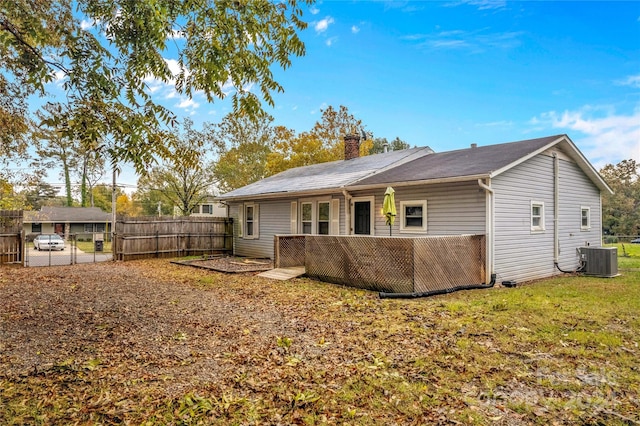 rear view of property with a deck and central AC unit