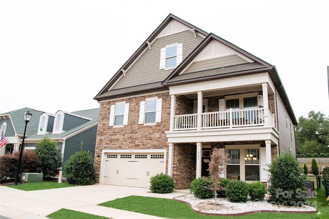 craftsman-style home with central AC unit, a garage, and a balcony