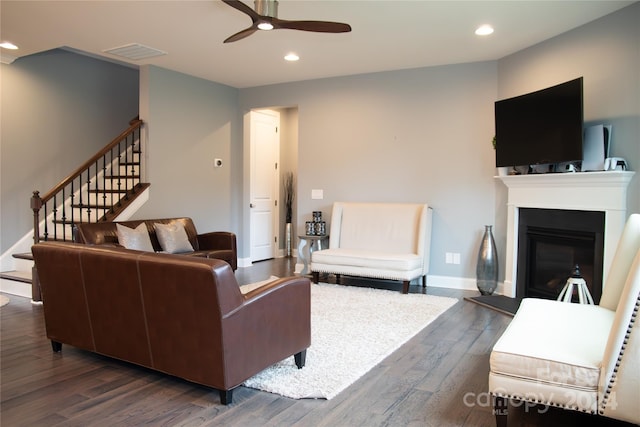 living room with dark hardwood / wood-style flooring and ceiling fan