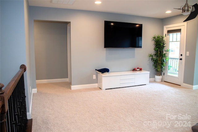 living room with ceiling fan and light colored carpet