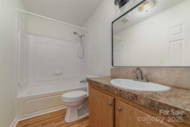 full bathroom with vanity, backsplash, wood-type flooring, toilet, and shower / bathing tub combination