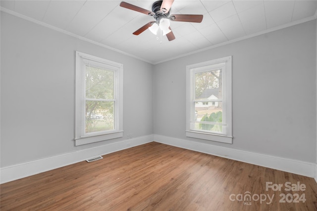 unfurnished room with ornamental molding, hardwood / wood-style flooring, and ceiling fan