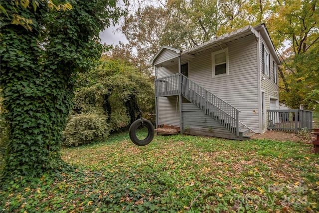 back of house with a deck