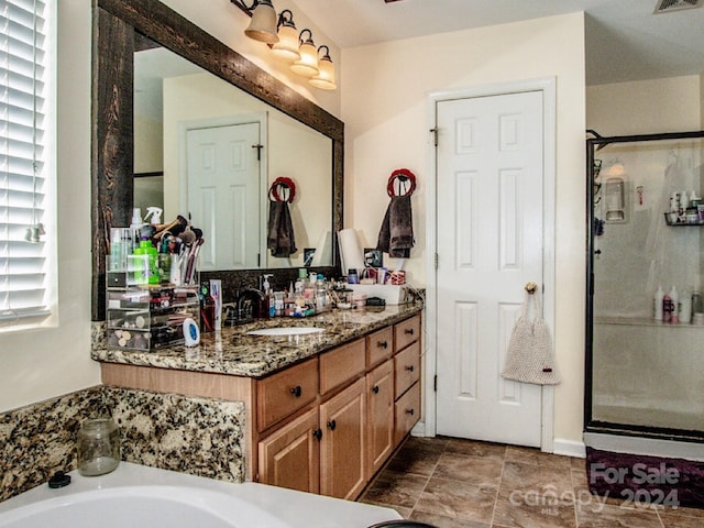 bathroom with vanity and independent shower and bath