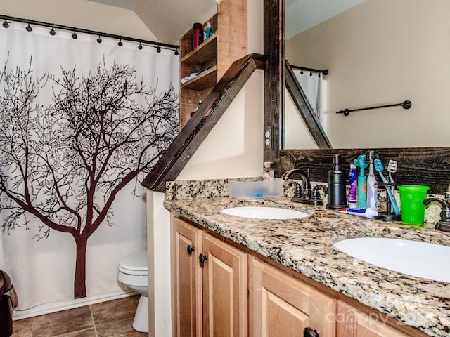 bathroom with vanity, toilet, walk in shower, and vaulted ceiling