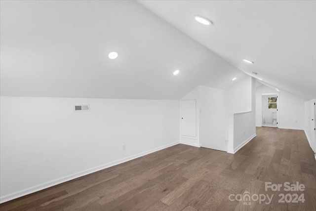 additional living space with lofted ceiling and dark hardwood / wood-style floors