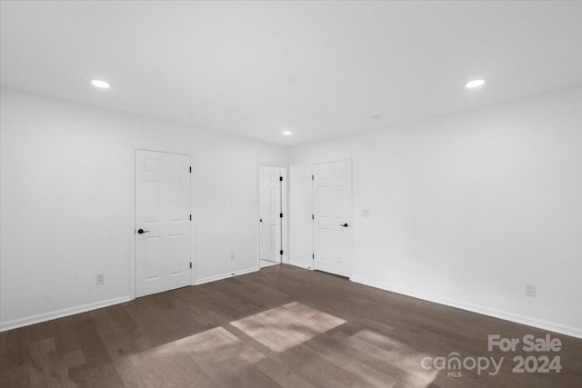 unfurnished room featuring dark wood-type flooring