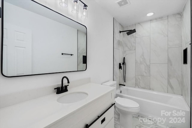 full bathroom with tiled shower / bath, toilet, and vanity