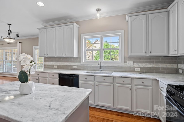 kitchen featuring white cabinetry, sink, tasteful backsplash, decorative light fixtures, and black appliances