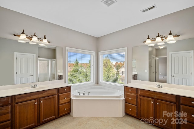 bathroom featuring tile patterned flooring, shower with separate bathtub, and vanity