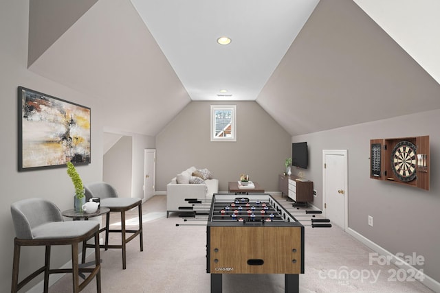 rec room featuring lofted ceiling and light carpet